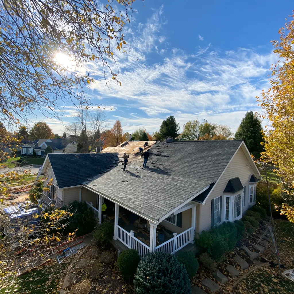 View from above of roofers stripping shingles on a house roof